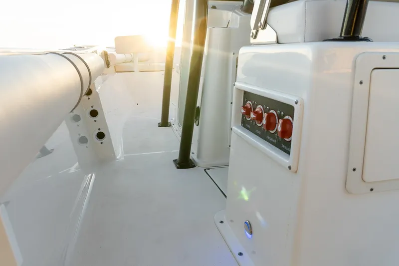 Slide: The Image of 2021 Sea Born LX24 Center Console boat interior with control panel, sunlit deck. - 23