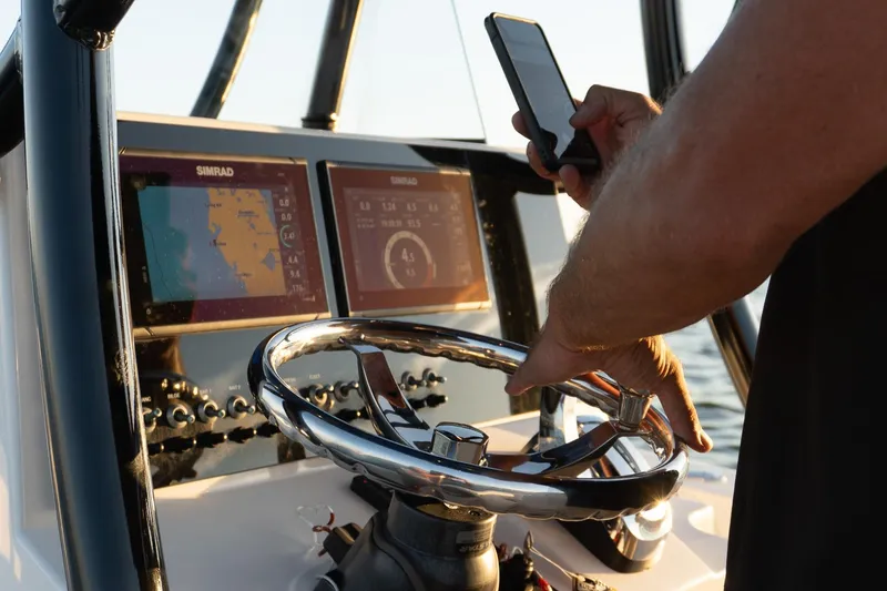 Slide: The Image of 2021 Sea Born LX24 Center Console dashboard with navigation screens and steering wheel. - 25