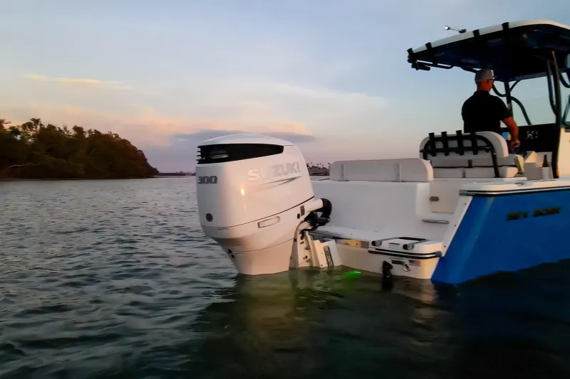 Slide: The Image of 2021 Sea Born LX24 Center Console boat with Suzuki 300 engine on calm water at sunset. - 26