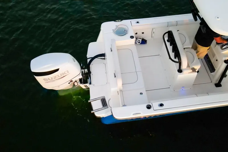 Slide: The Image of 2021 Sea Born LX24 Center Console boat with Suzuki outboard engine on water. - 30