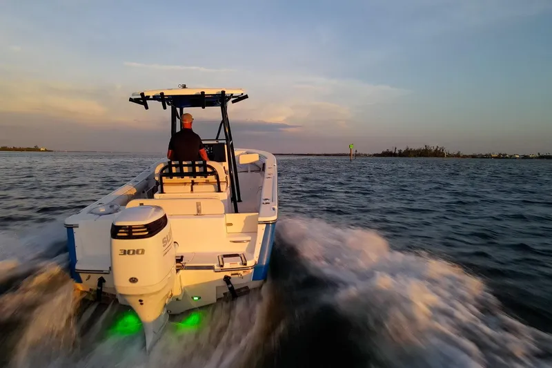Slide: The Image of 2021 Sea Born LX24 Center Console boat cruising at sunset on open water. - 33