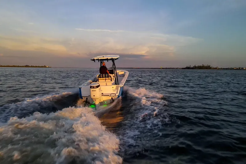 Slide: The Image of 2021 Sea Born LX24 Center Console boat cruising on open water at sunset. - 34