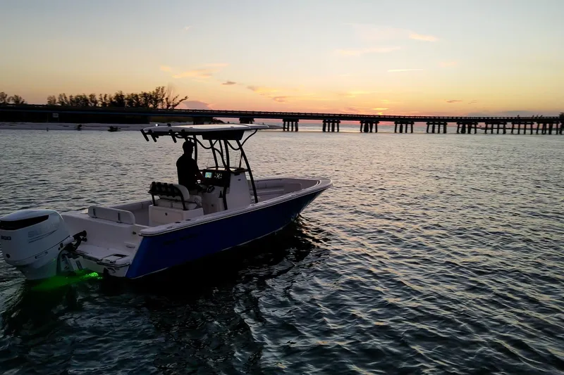 Slide: The Image of 2021 Sea Born LX24 Center Console boat at sunset on calm waters. - 5
