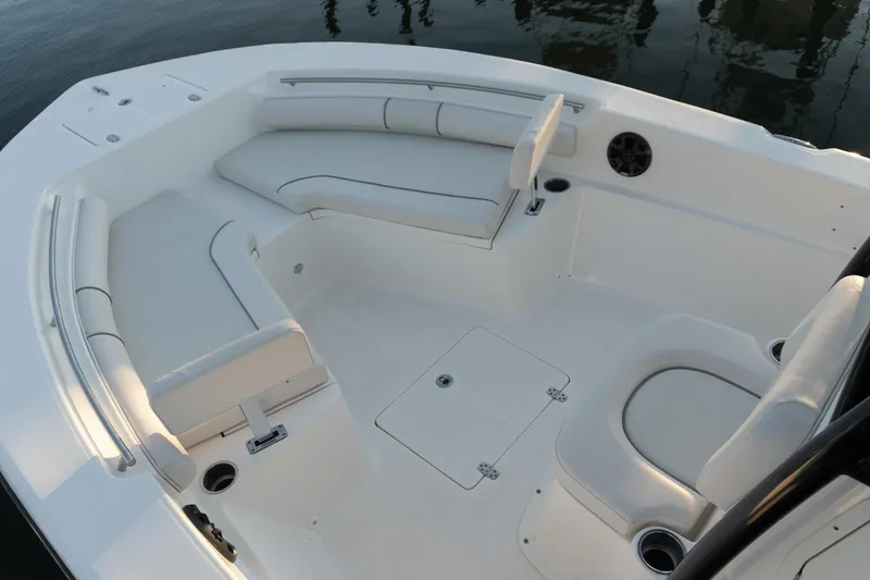 Slide: The Image of 2021 Sea Born LX24 Center Console boat interior with white seating and cup holders. - 8