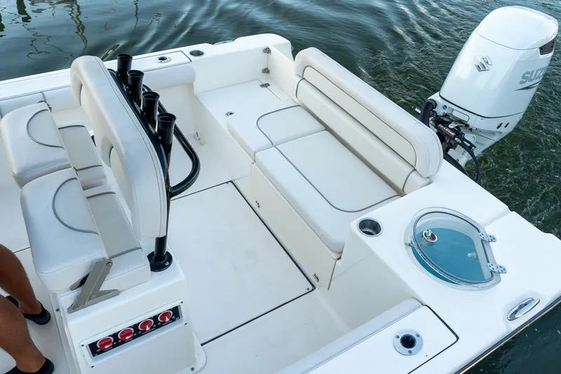 Slide: The Image of 2021 Sea Born LX24 Center Console boat interior with seating and Suzuki outboard motor. - 9