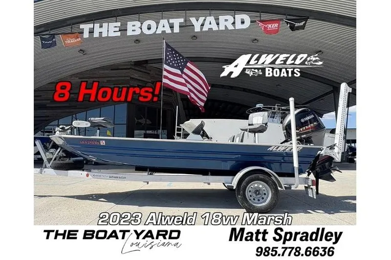 The Image of 2023 Alweld 18vv Marsh boat at The Boat Yard, Louisiana, with American flag and contact info. - 0