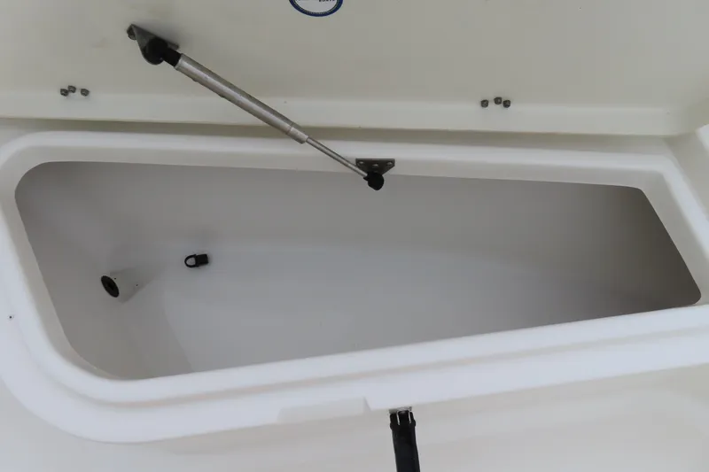 Slide: The Image of Open storage compartment on 2017 NauticStar 25 XS Offshore boat. - 11