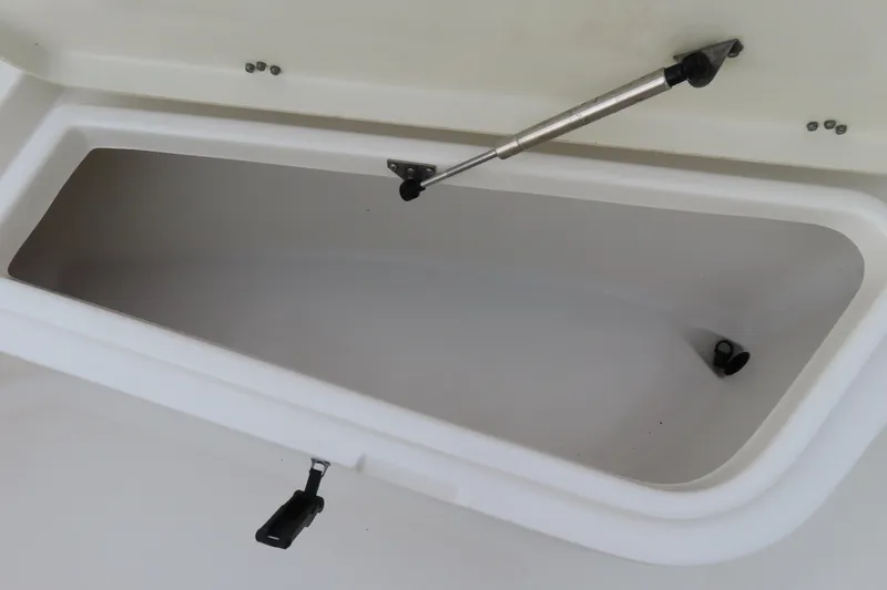 Slide: The Image of Open storage compartment on 2017 NauticStar 25 XS Offshore boat. - 12
