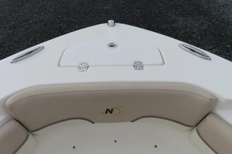 Slide: The Image of 2017 NauticStar 25 XS Offshore boat bow with cushioned seating and storage hatch. - 13
