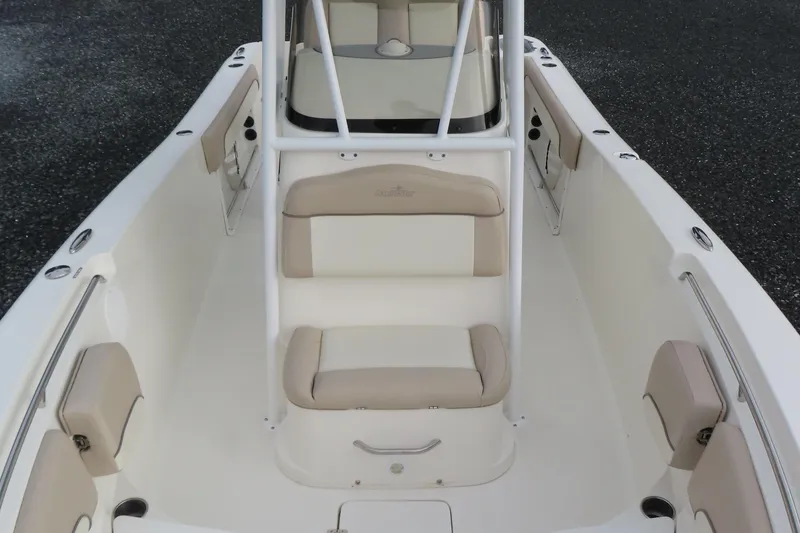 Slide: The Image of 2017 NauticStar 25 XS Offshore boat interior with beige seating and white deck. - 15
