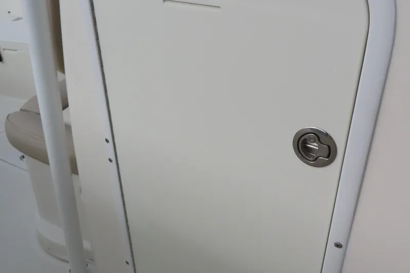 Slide: The Image of 2017 NauticStar 25 XS Offshore boat interior door with handle detail. - 20