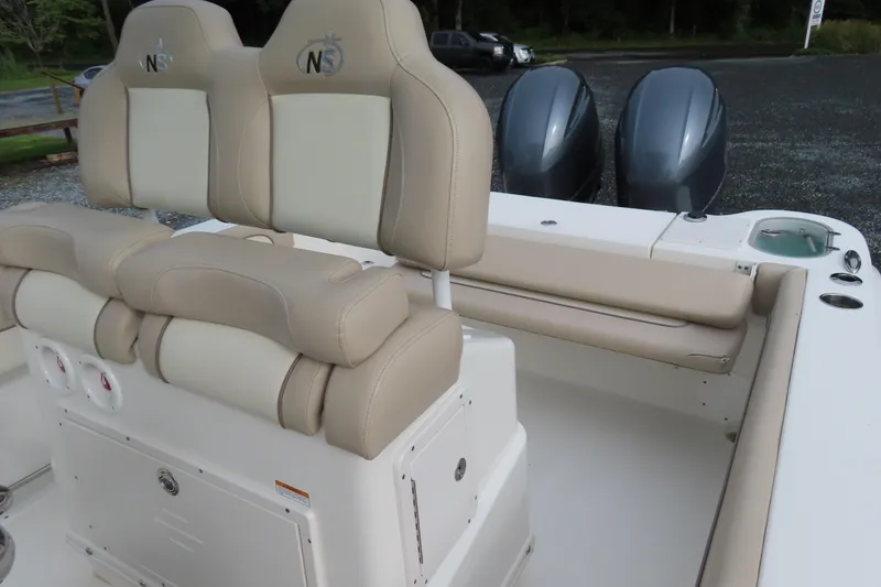 Slide: The Image of 2017 NauticStar 25 XS Offshore boat interior with dual seats and twin engines. - 22