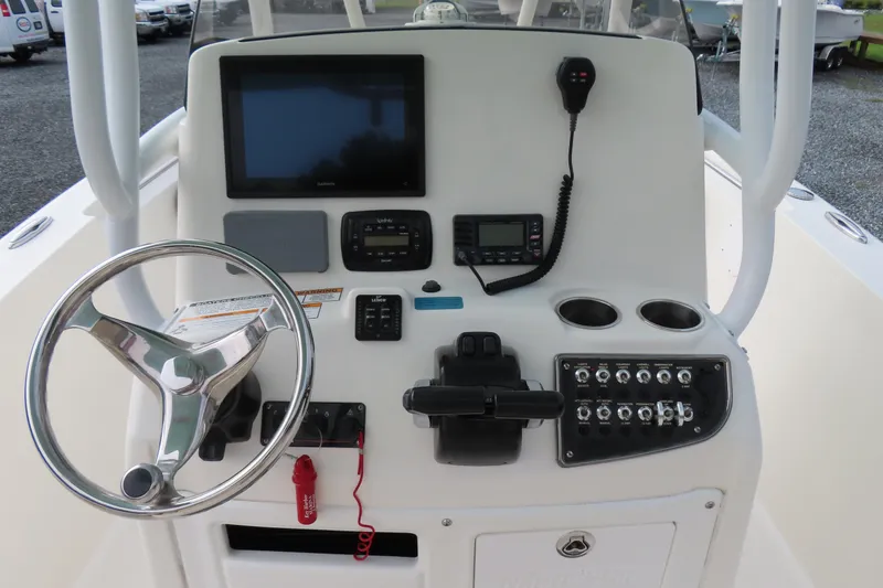 Slide: The Image of 2017 NauticStar 25 XS Offshore boat console with steering wheel and navigation controls. - 25