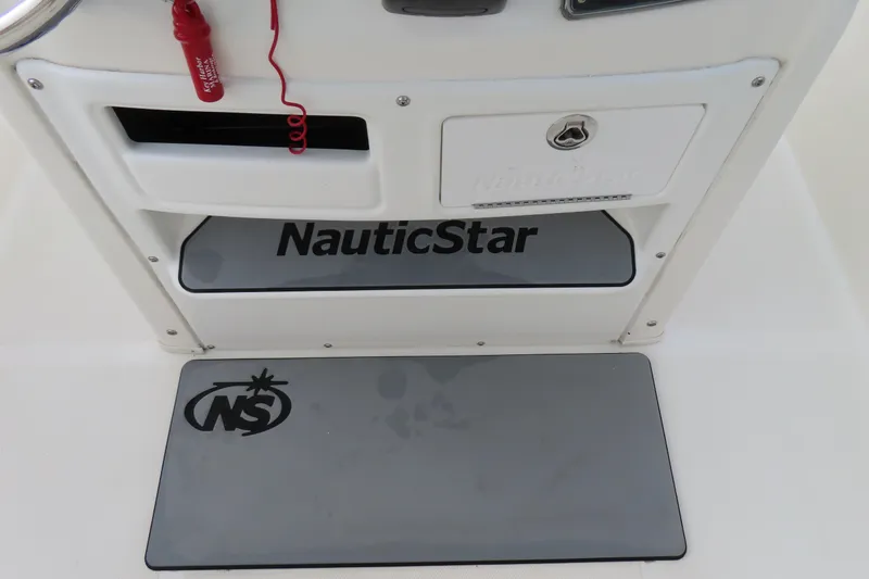 Slide: The Image of 2017 NauticStar 25 XS Offshore boat console with branded mat and safety cord. - 26