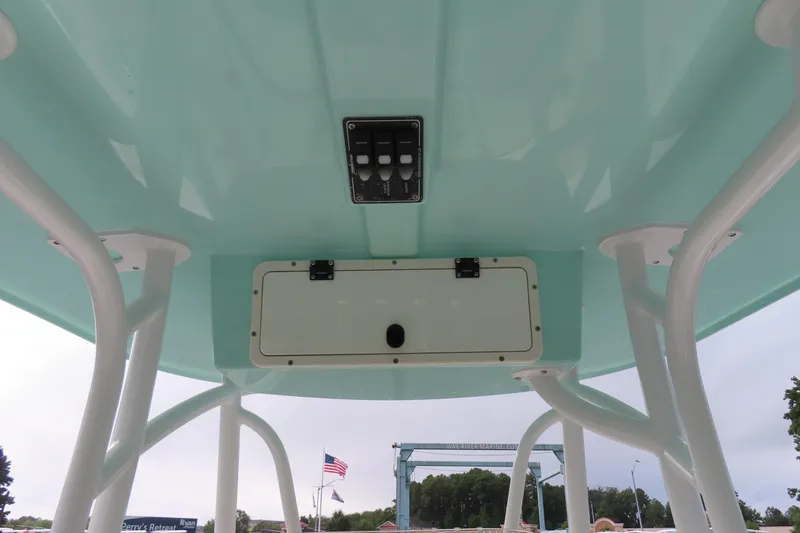 Slide: The Image of 2017 NauticStar 25 XS Offshore boat's T-top with control panel and storage compartment. - 27