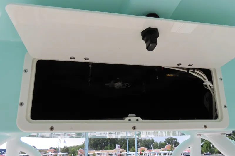 Slide: The Image of Open storage compartment on 2017 NauticStar 25 XS Offshore boat, showing interior wiring. - 28