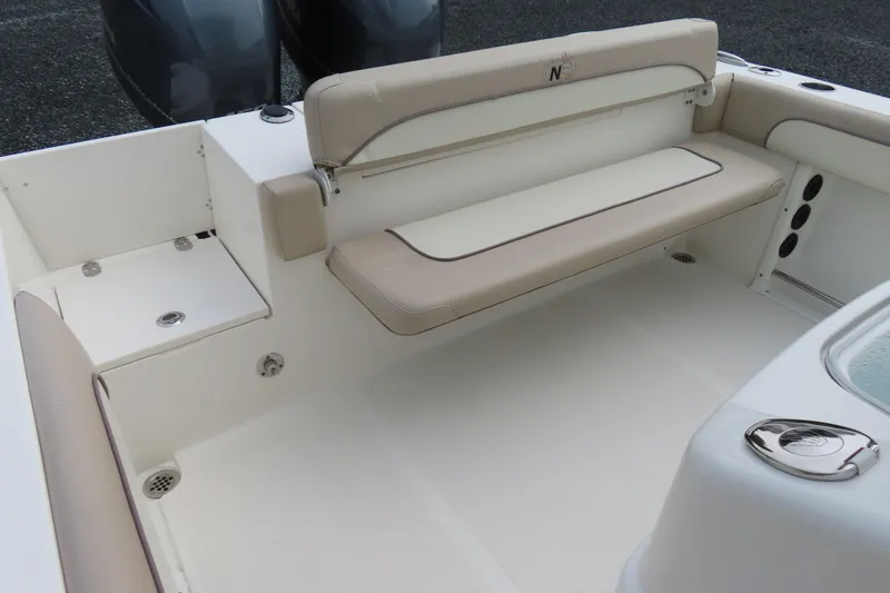 Slide: The Image of 2017 NauticStar 25 XS Offshore boat interior with beige seating and storage compartments. - 29