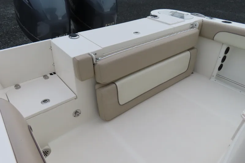 Slide: The Image of 2017 NauticStar 25 XS Offshore boat interior with beige seating and dual engines. - 33