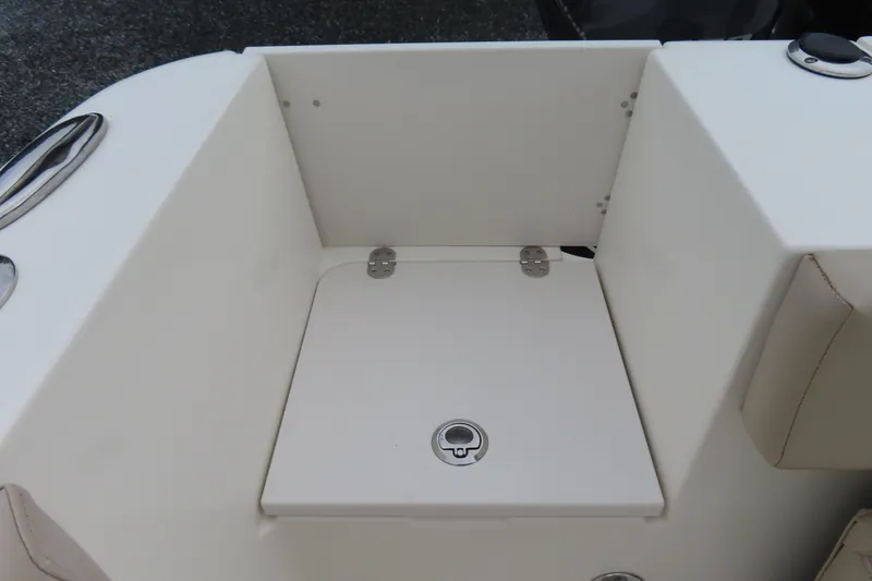 Slide: The Image of 2017 NauticStar 25 XS Offshore boat storage compartment with secure latch. - 34