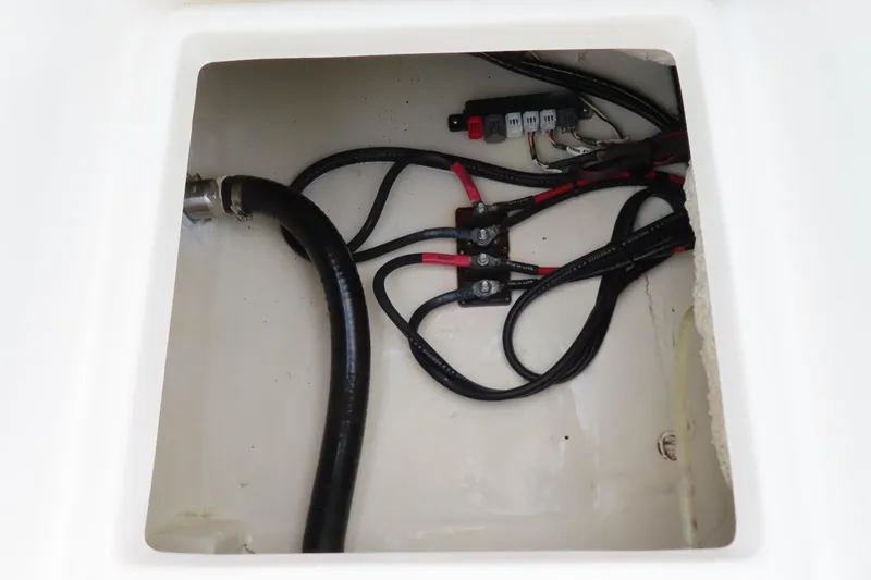 Slide: The Image of 2017 NauticStar 25 XS Offshore boat wiring compartment with cables and connectors. - 35