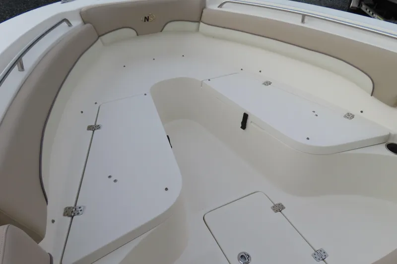 Slide: The Image of 2017 NauticStar 25 XS Offshore boat interior with cushioned seating and storage compartments. - 8