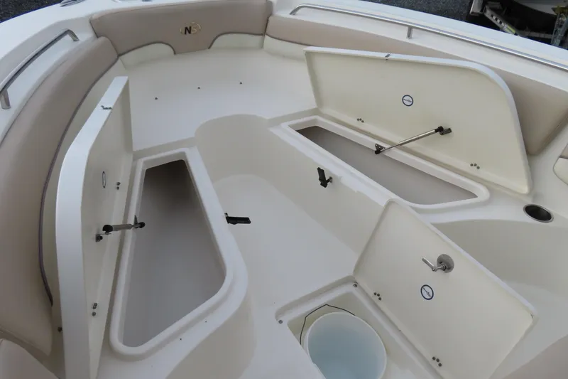 Slide: The Image of 2017 NauticStar 25 XS Offshore boat interior with open storage compartments. - 9