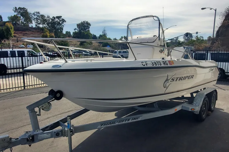 Slide: The Image of 2005 Seaswirl Striper 1851 Center Console boat on trailer, parked outdoors. - 1