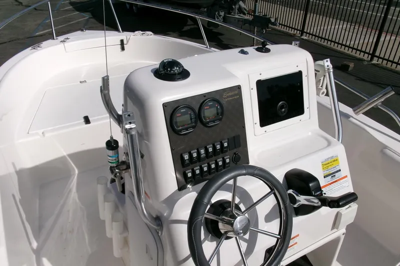 Slide: The Image of 2005 Seaswirl Striper 1851 Center Console boat interior with steering wheel and control panel. - 14