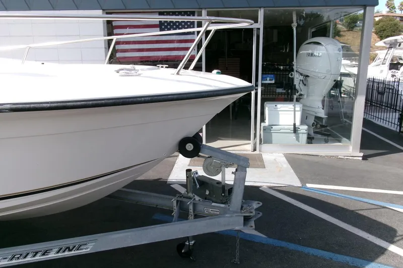 Slide: The Image of 2005 Seaswirl Striper 1851 Center Console boat on trailer, with American flag in background. - 26
