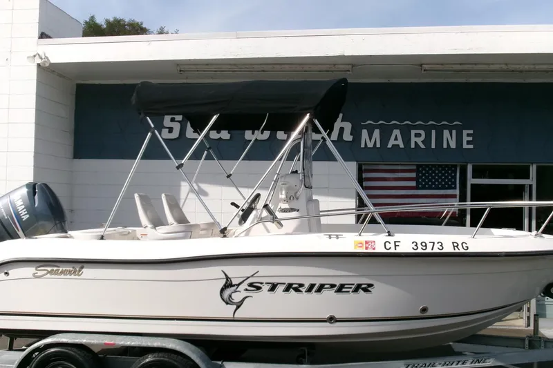 Slide: The Image of 2005 Seaswirl Striper 1851 Center Console boat on trailer outside marine shop. - 28