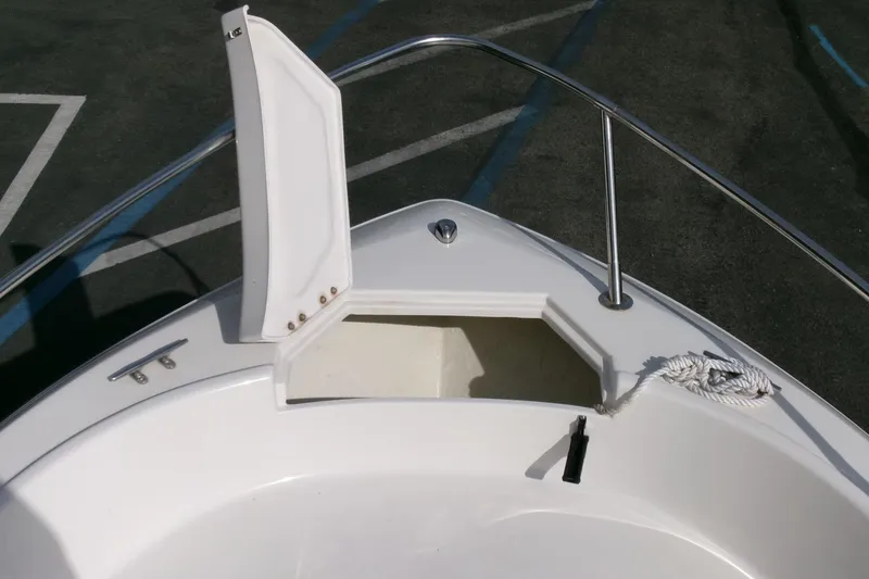 Slide: The Image of 2005 Seaswirl Striper 1851 Center Console boat with open storage compartment and rope. - 5