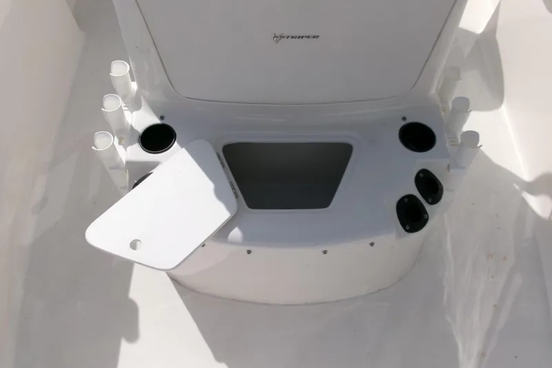Slide: The Image of 2005 Seaswirl Striper 1851 Center Console boat interior with rod holders and storage compartment. - 9