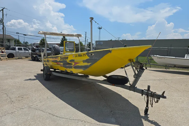 Slide: The Image of Yellow Rookie 22 boat on trailer, 2006 model, parked outdoors under blue sky. - 2
