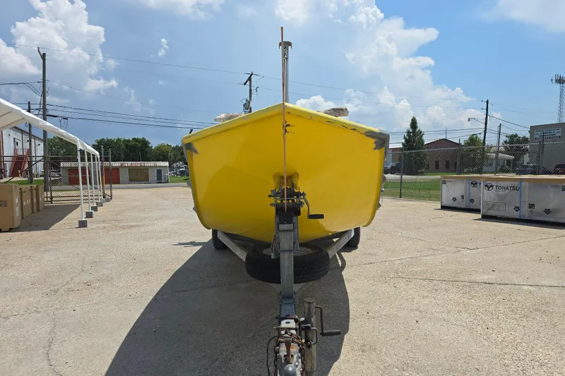 Slide: The Image of Yellow Rookie 22 boat from 2006 on a trailer in a sunny outdoor setting. - 4