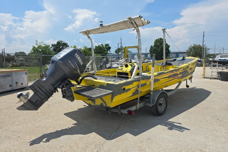 Slide: The Image of Yellow Rookie 22 boat with Yamaha motor, parked on trailer, sunny day. - 7
