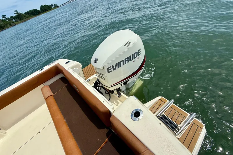 Slide: The Image of 2015 Scout 245 Dorado boat with Evinrude engine on calm water. - 6