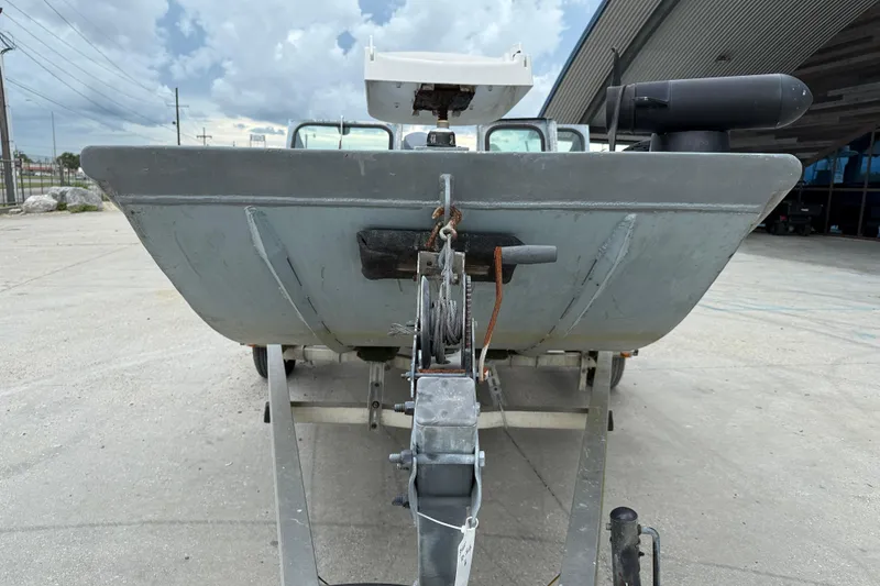 Slide: The Image of 1983 Scully's 16 WT boat on trailer, parked outdoors under cloudy sky. - 2