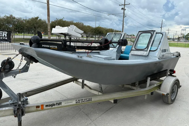 Slide: The Image of 1983 Scully's 16 WT boat on trailer with Minn Kota Maxxum motor, parked outdoors. - 3