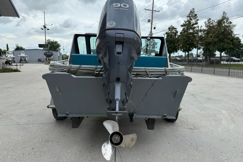 Slide: The Image of 1983 Scully's 16 WT boat with 90 HP outboard motor, parked outdoors. - 4