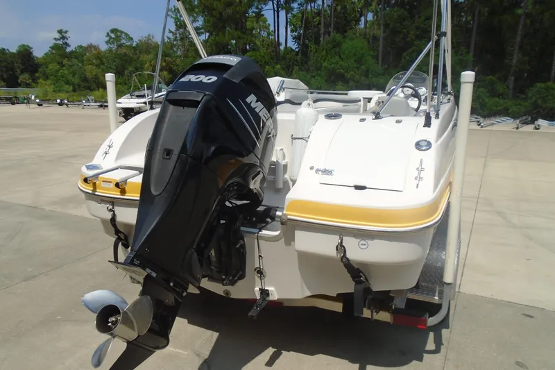 Slide: The Image of 2013 Starcraft Limited 1915 OB boat with Mercury 200 engine, parked outdoors. - 11