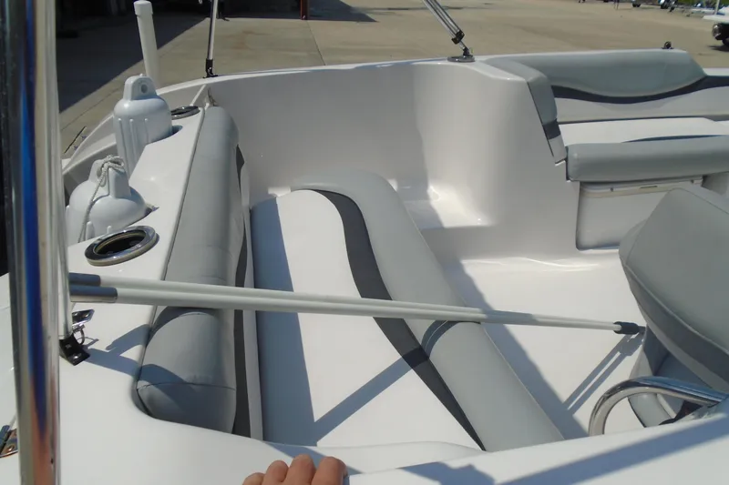 Slide: The Image of 2013 Starcraft Limited 1915 OB boat interior with gray seating and cup holders. - 12