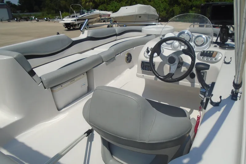 Slide: The Image of 2013 Starcraft Limited 1915 OB boat interior with steering wheel and seating. - 13