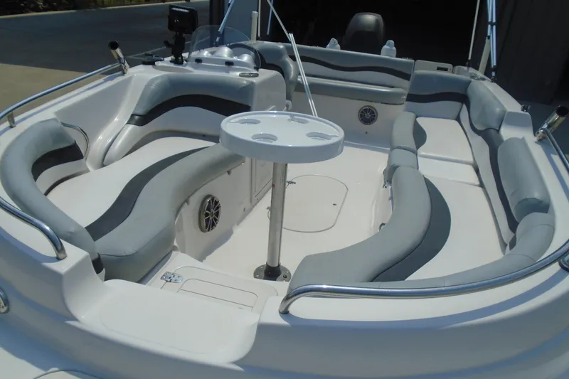 Slide: The Image of 2013 Starcraft Limited 1915 OB boat interior with gray seating and round table. - 17