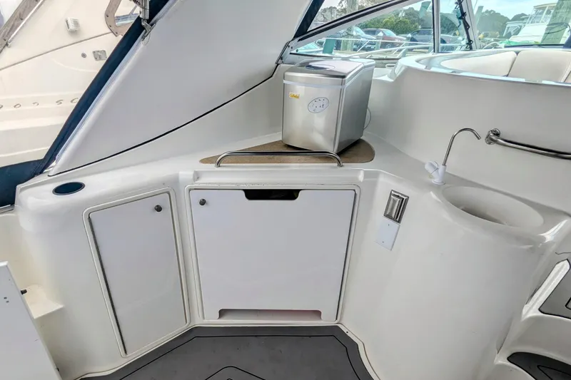 Slide: The Image of 2000 Cruisers Yachts 3870 Express interior with kitchenette and ice maker. - 12