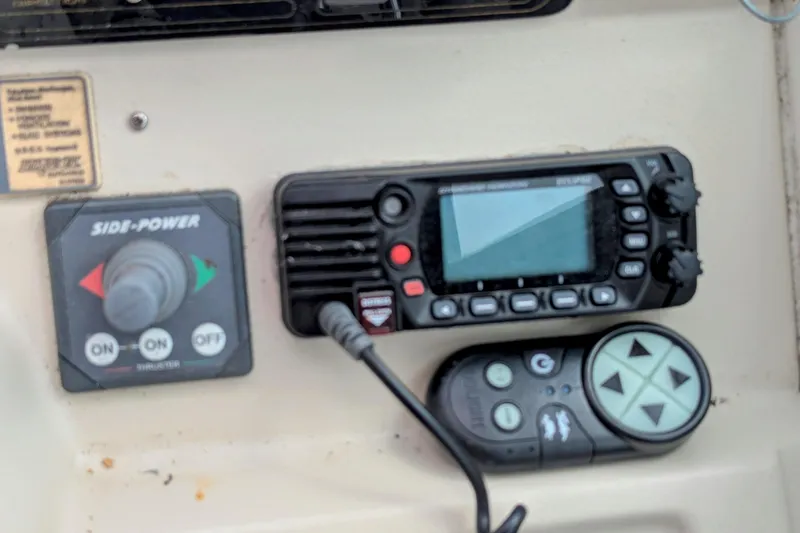 Slide: The Image of Control panel of a 2000 Cruisers Yachts 3870 Express with navigation and thruster controls. - 13