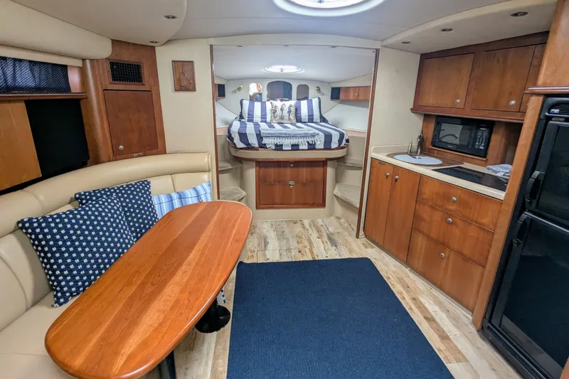 Slide: The Image of Luxurious interior of 2000 Cruisers Yachts 3870 Express with cozy seating and kitchenette. - 16