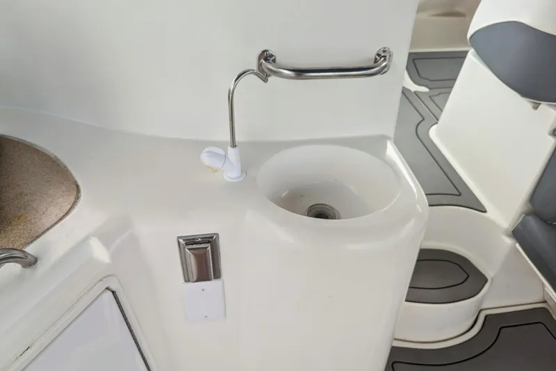 Slide: The Image of 2000 Cruisers Yachts 3870 Express interior with sink and seating area. - 32