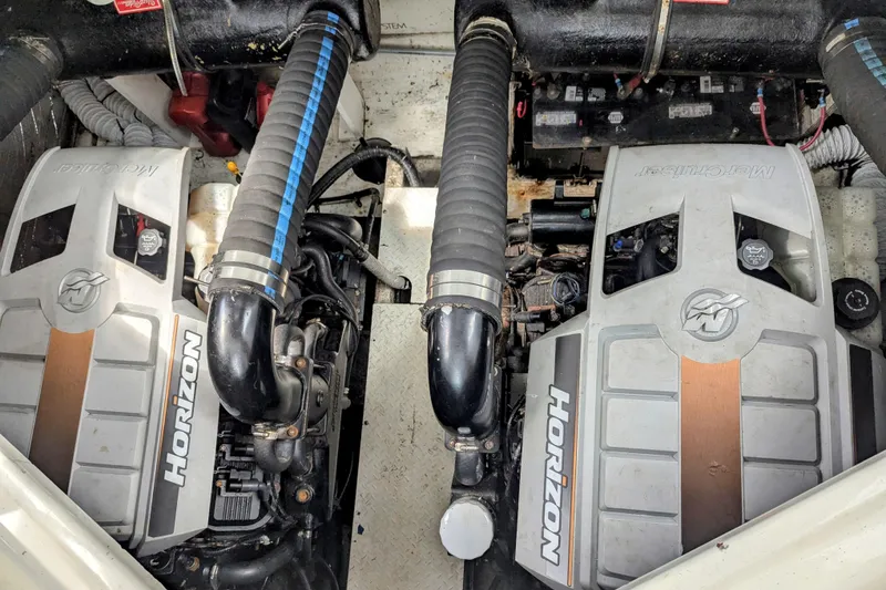 Slide: The Image of Engine compartment of a 2000 Cruisers Yachts 3870 Express, featuring twin Horizon engines. - 34