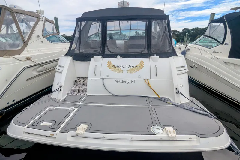 Slide: The Image of 2000 Cruisers Yachts 3870 Express docked, featuring "Angels Envy" nameplate, Westerly, RI. - 5