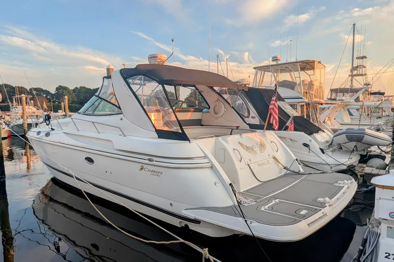 The Image of 2000 Cruisers Yachts 3870 Express docked at marina during sunset. - 0